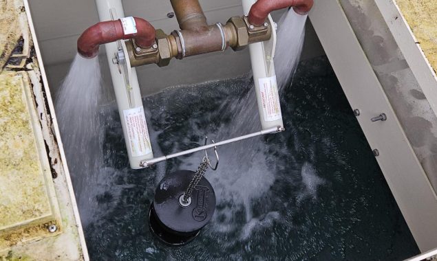 A picture of a cold water storage tank, also known as a break tank, with the pumps filling it with water