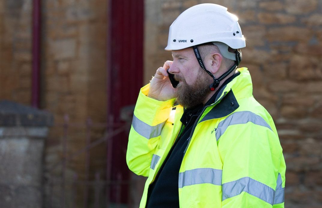 A Willow Pumps engineer in high-vis on the phone